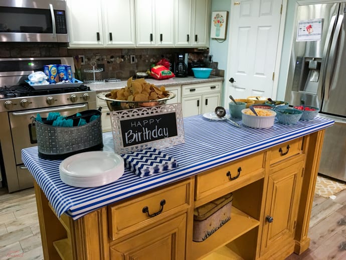 nacho food bar with blue and white striped tablecloth