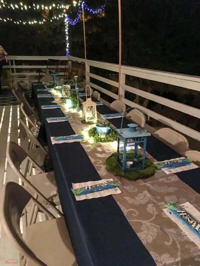 party table at night lit with string lights