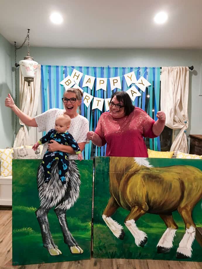 two women posing with painted photo prop