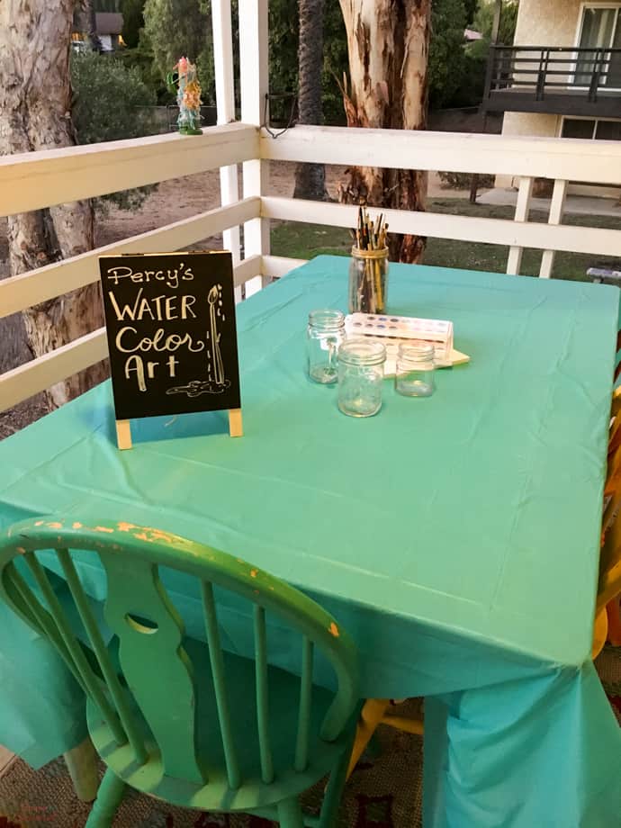 water color table with brushes, paint and paper