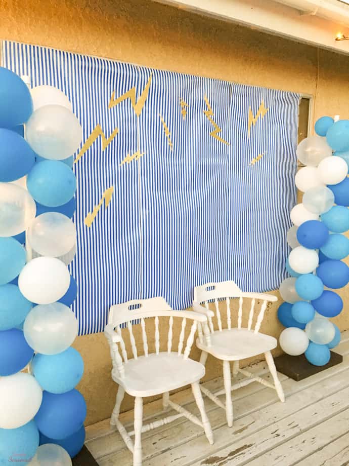 photo backdrop with chairs and blue and white balloons