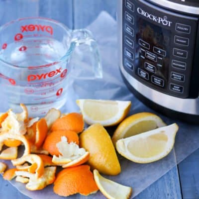 How to remove cooking odors: orange rinds, lemons, cleaning solution and Crockpot Express on a table