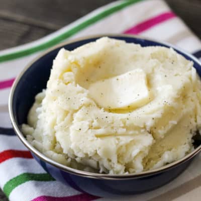 mashed potatoes in a bowl with striped napkin