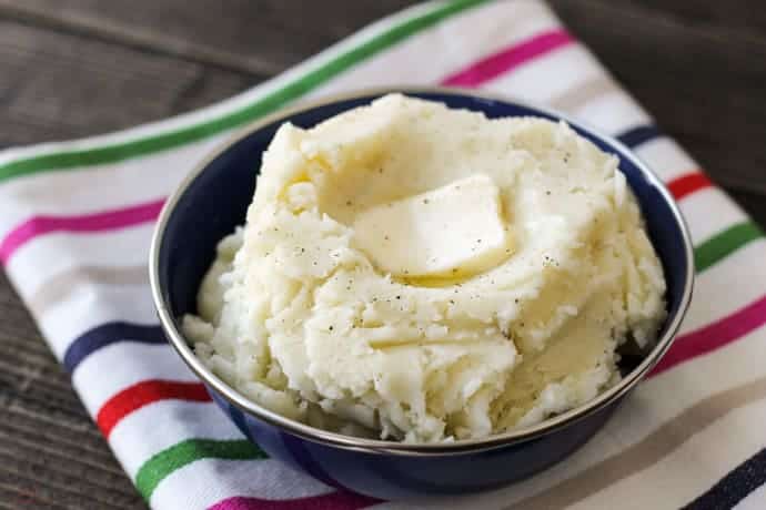 mashed potatoes in a bowl with striped napkin