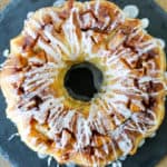 Chunks of tart apples, a sweet glaze and a brown sugar crackle on top make this Crockpot Express Apple Fritter Cake a delicious dessert that's ready in less than an hour (without heating up the kitchen!)