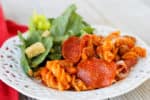 Crockpot Express Pizza Pasta is a family friendly dinner that you can easily adjust with your own favorite pizza toppings! Serve with breadsticks and salad for a satisfying and delicious dinner.