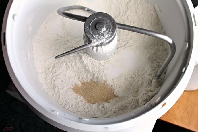 Combine flour, yeast, salt, and sugar in mixing bowl