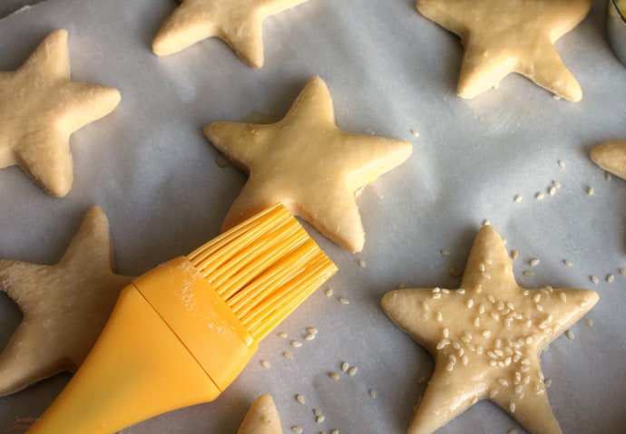 Brush stars with whisked egg white and sprinkle with sesame seeds