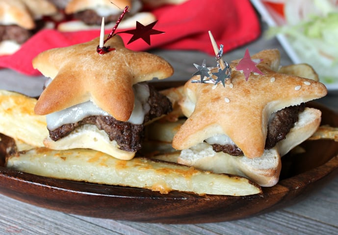 star shaped cheeseburgers on tray with potato wedges