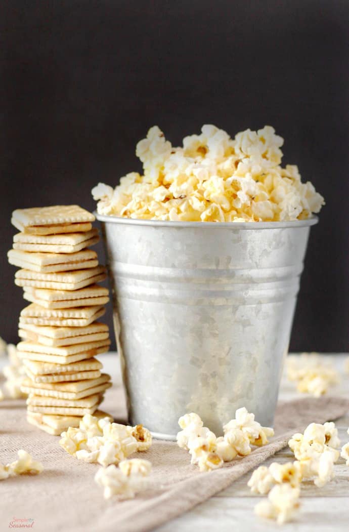 popcorn and crackers on a table