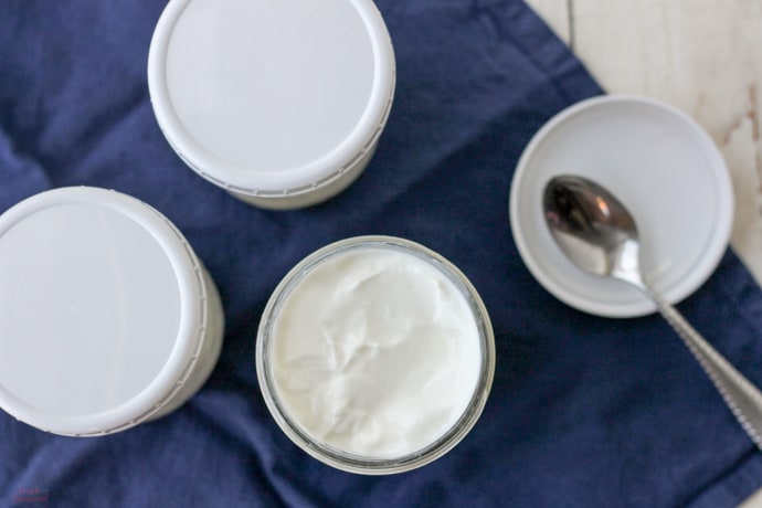 top down view of glass jars filled with yogurt and screw on reusable lids