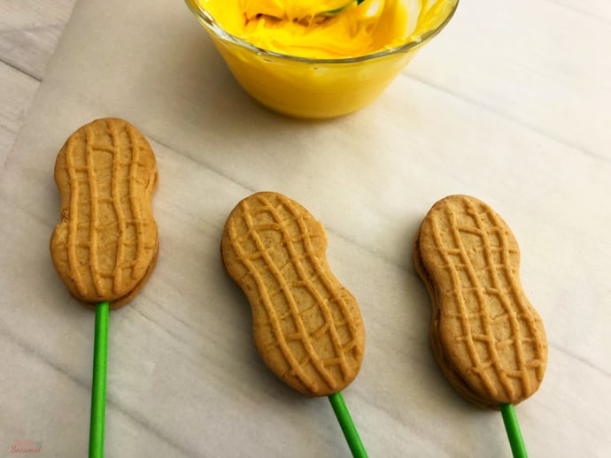 3 cookies with lollipop sticks added to the centers