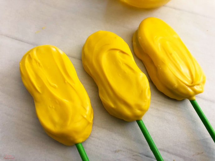 cookie pops dipped in yellow melting candy