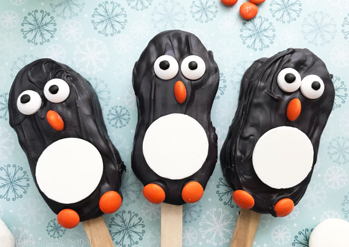 3 cookie/candy penguins on popsicle sticks