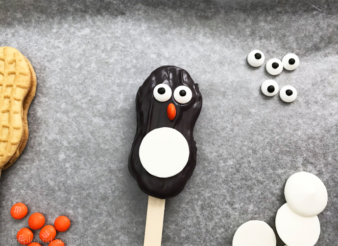 candy disk to create the white belly of a penguin cookie