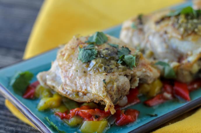 chicken thigh on bed of cooked peppers