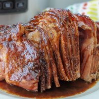 Save space in the oven by making Crockpot Express Ham. Add a delicious copycat HoneyBaked ham glaze for the perfect holiday dinner.