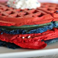 close up of red and blue 4th of July waffles with whipped topping