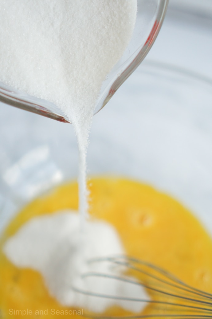 pouring sugar into lemon mixture