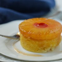 closeup of cake with pineapple ring on top