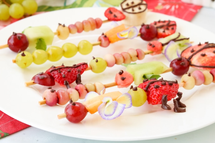 side view of plate full of fruit kabobs