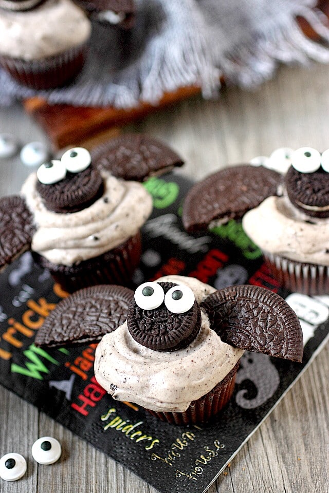 cupcake topped with mini oreos decorated to look like bats