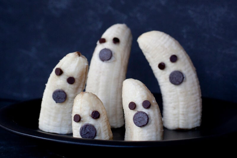 bananas decorated with chocolate chips to look like ghosts