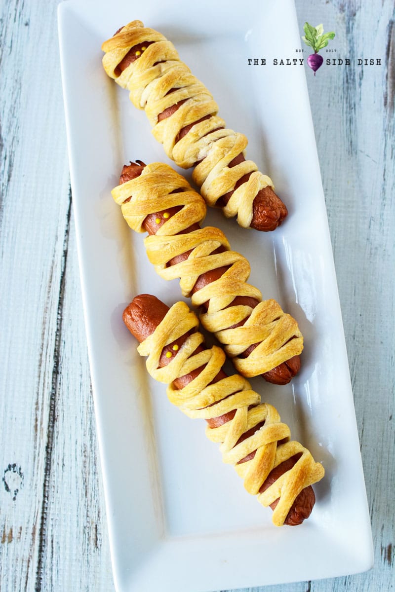 3 hot dogs wrapped in dough to look like mummies