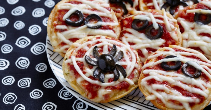 spider web pizzas on a black and white plate
