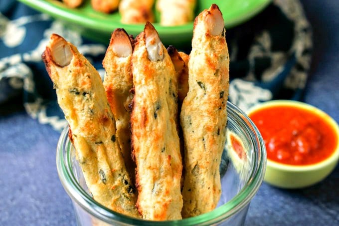 breadsticks shaped like fingers in a bowl with dipping sauce
