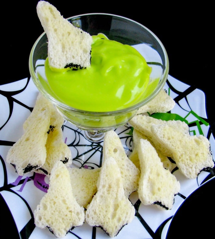 green dip with bread cut to look like noses for dipping