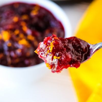 spoonful of cranberry sauce with yellow napkin in the background
