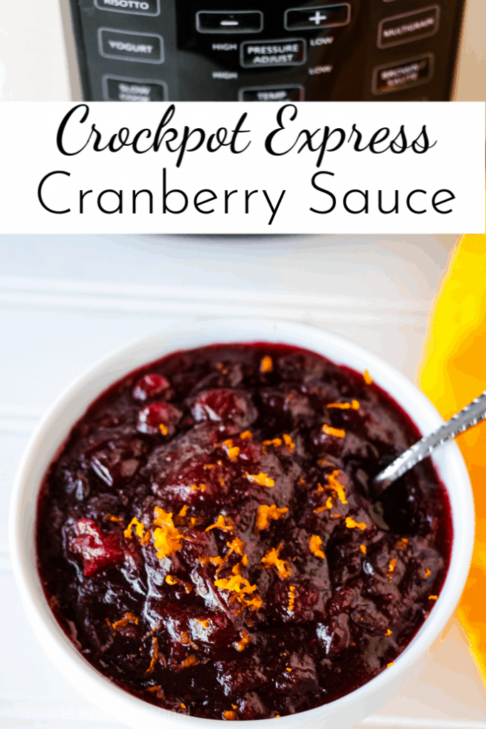 pressure cooker in the background and bowl of cranberry sauce with orange zest garnish