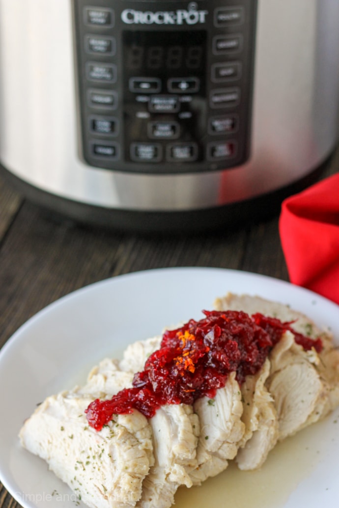 sliced turkey breast on a plate with cranberry sauce