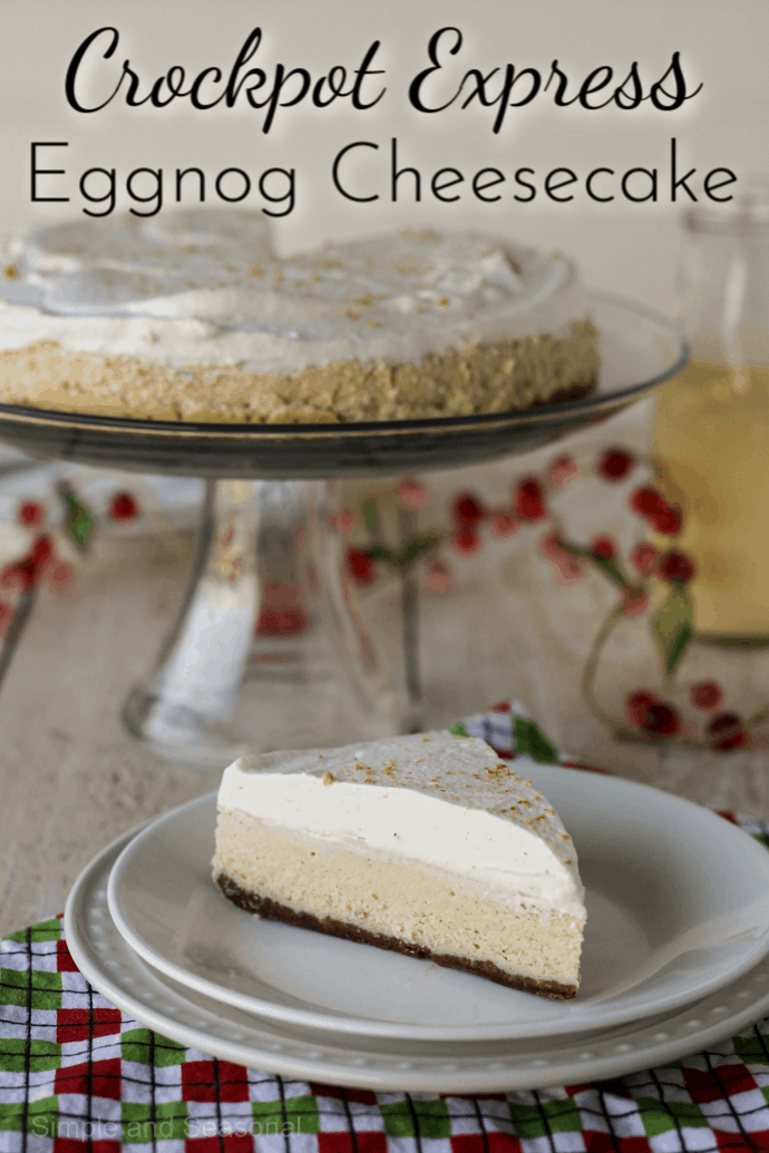 slice of cheesecake on a plate in front of whole cheesecake in background; label reads: crockpot express eggnog cheesecake