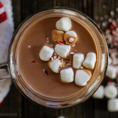 top down view of crockpot express hot chocolate in a mug with marshmallows and crushed peppermint