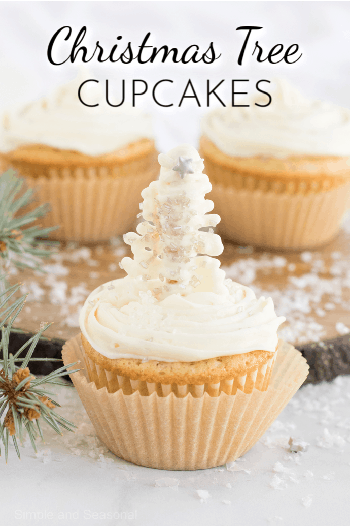 cupcake with white frosting and white candy christmas tree; photo label reads: Christmas Tree Cupcakes