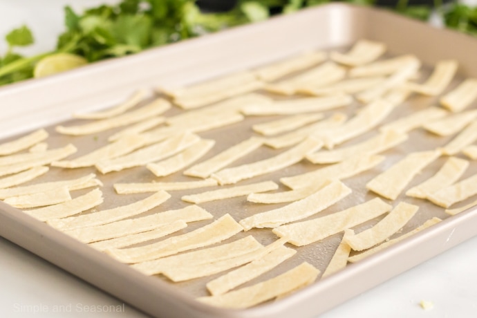 tortillas strips ready to bake on sheet pan