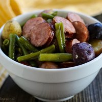 green beans, purple potatoes and sliced sausage in a bowl