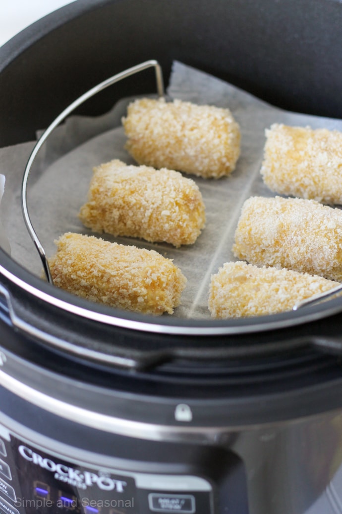 fish sticks on a cooking rack inside the Crockpot Express Crisp