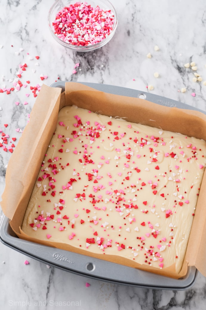 square pan with fudge covered in Valentine sprinkles