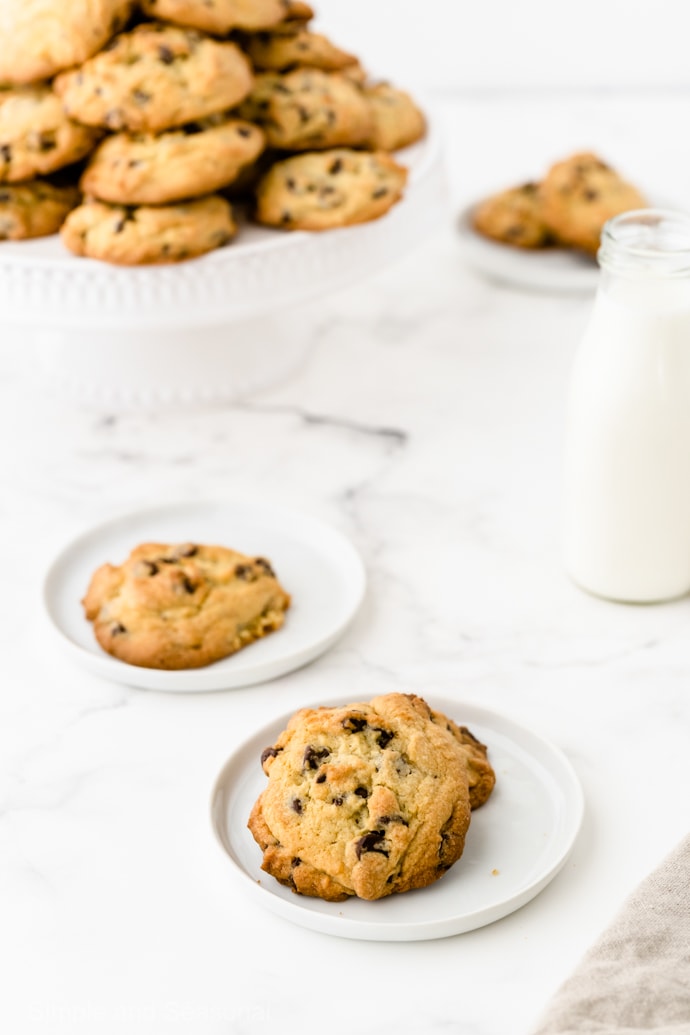 chewy chocolate chip cookies on a plate with milk