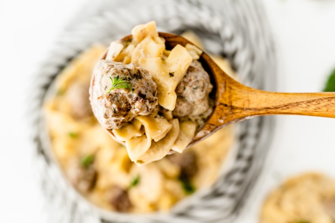 spoonful of meatballs and noodles with cream sauce