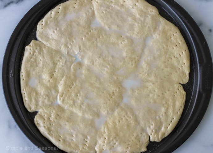 pizza crust brushed with milk and dusted with sugar
