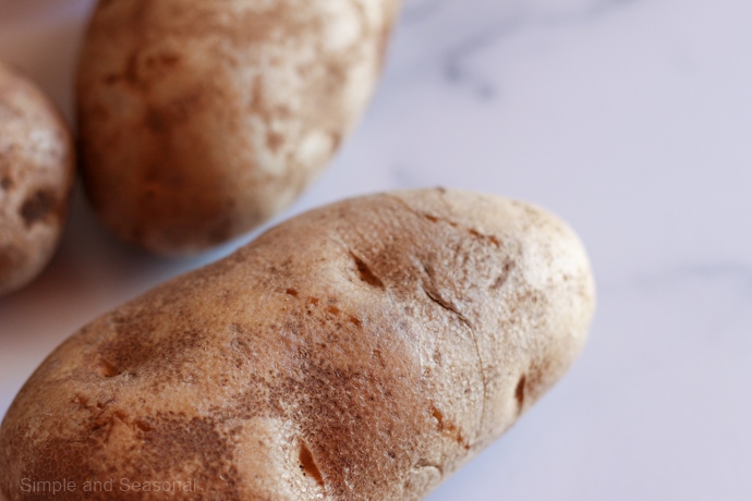 closeup of potato with puncture marks from a fork