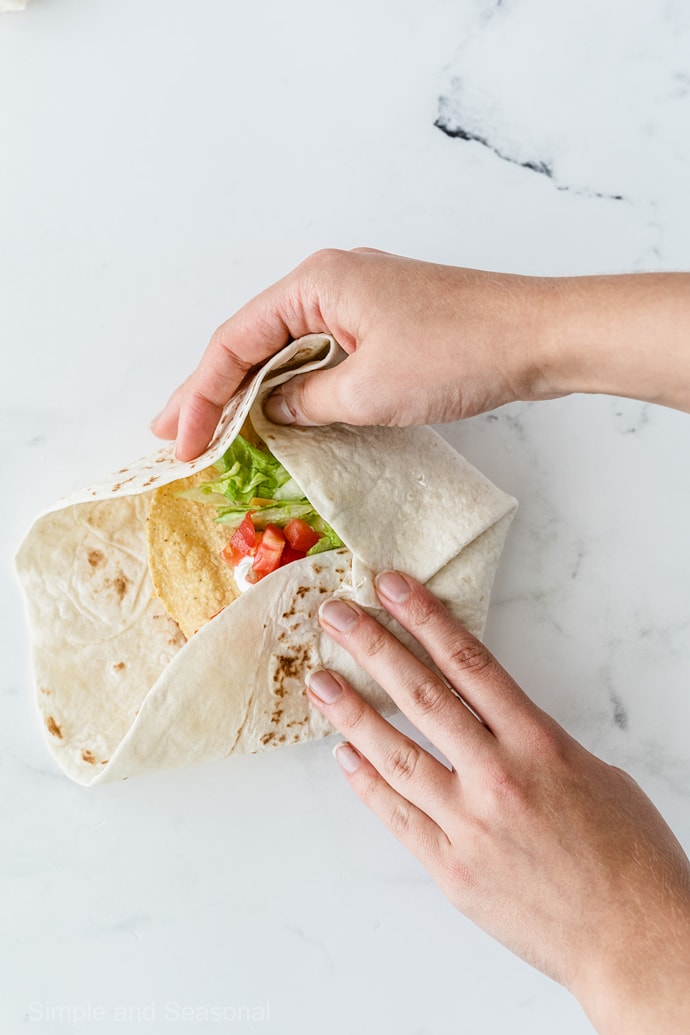 folding flour tortilla around center