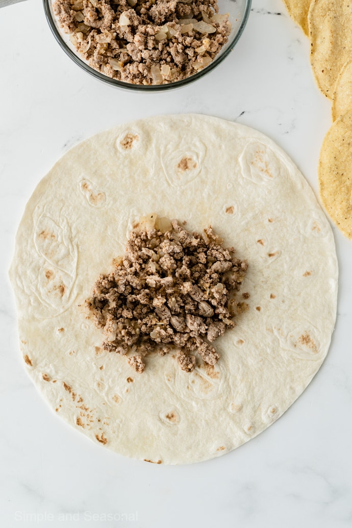 large tortilla with taco meat in the center