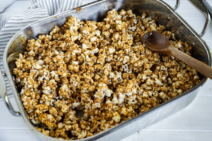 caramel mixture coated popcorn in a roasting pan