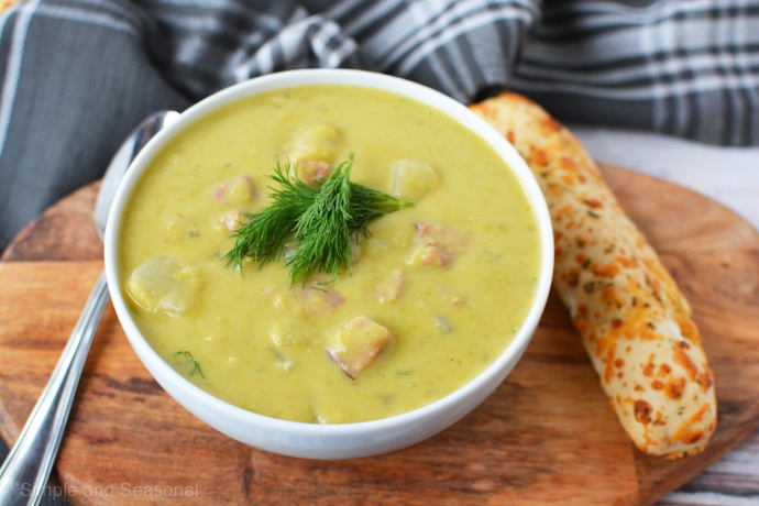 bowl of slow cooker split pea soup with dill garnish