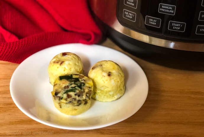 cooked egg bites on a plate with the Crockpot Express in the background